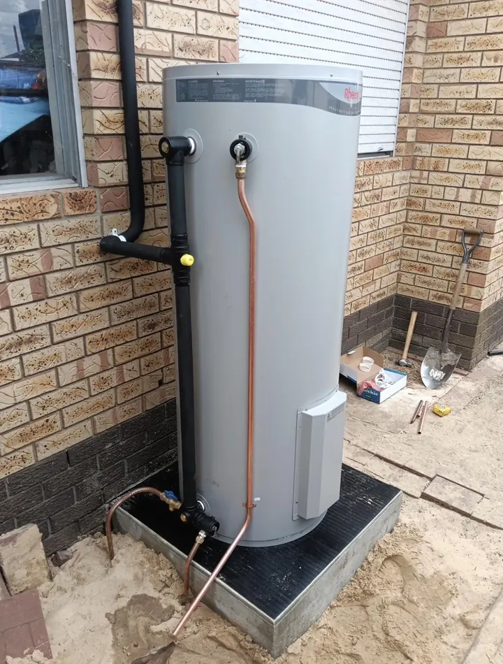 New Rheem electric hot water system installed on a new base by Lush Plumbing & Gas in Perth