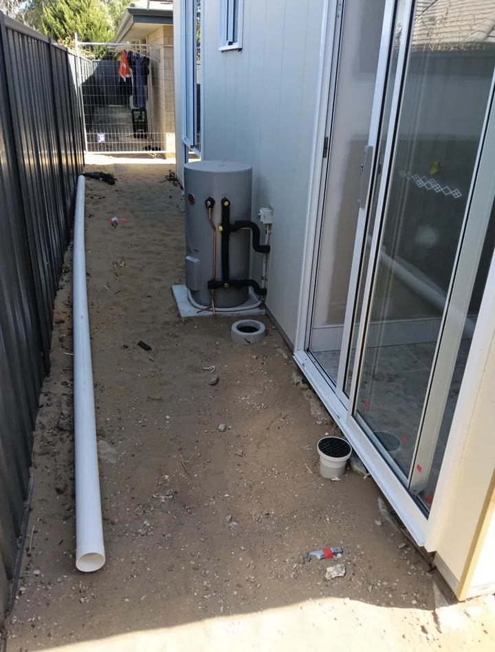 Compact electric hot water system installed in a side passage by Lush Plumbing & Gas in Perth